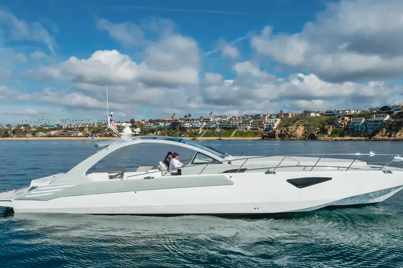 Slide: The Image of Luxurious 2017 Custom 60 yacht cruising near scenic coastal homes under blue skies. - 1