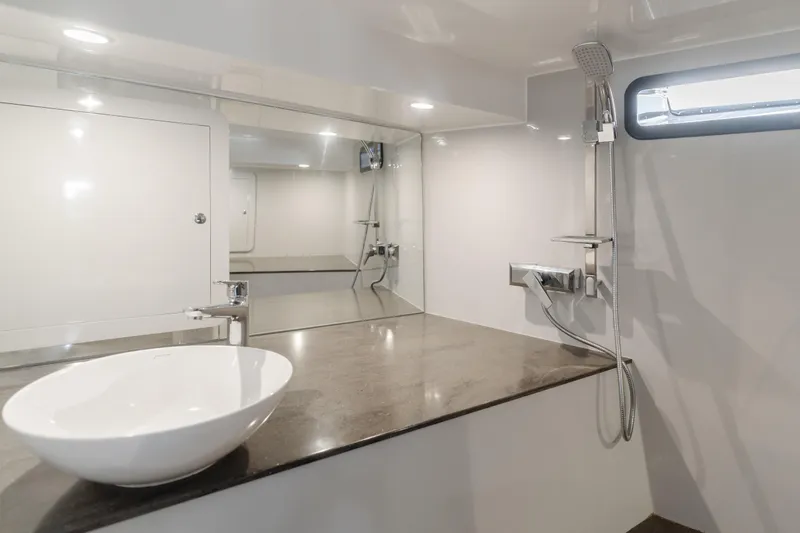 Slide: The Image of Modern bathroom with sleek fixtures, vessel sink, and large mirror in a Custom 60 yacht, 2017. - 25