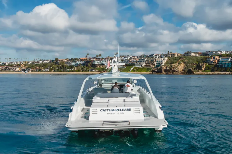 Slide: The Image of Custom 60 yacht cruising near coastal homes under a partly cloudy sky, 2017 model. - 3