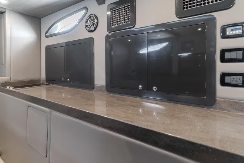 Slide: The Image of Modern interior of a 2017 Custom 60 vehicle with sleek cabinets and control panels. - 30