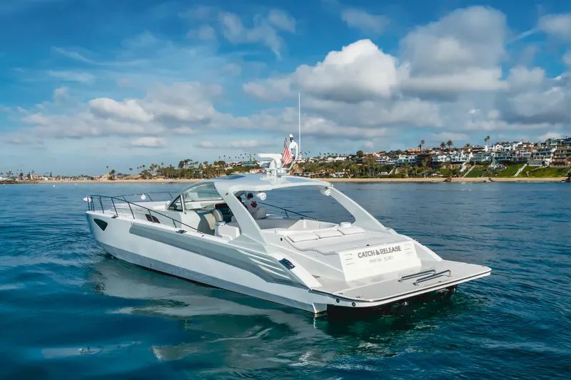 Slide: The Image of Luxurious 2017 Custom 60 yacht cruising near scenic coastal homes under a partly cloudy sky. - 4