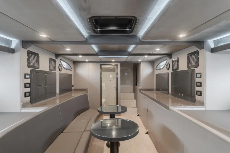 Slide: The Image of Modern interior of a 2017 Custom 60 yacht with sleek seating and tables. - 43