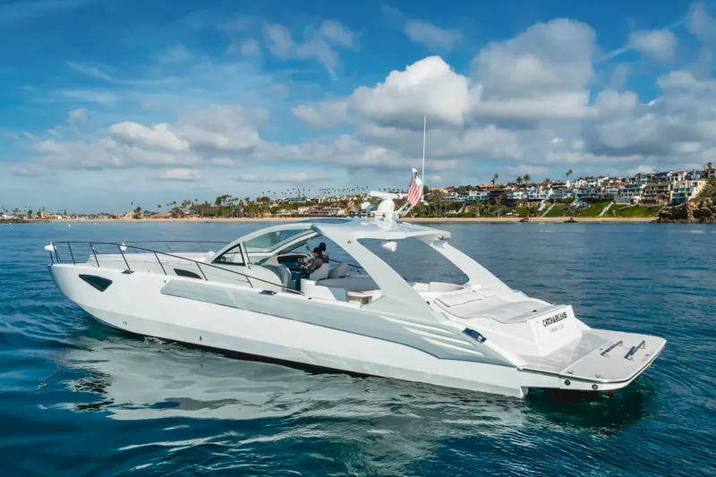 Slide: The Image of Luxurious 2017 Custom 60 yacht cruising near scenic coastal homes under a blue sky. - 5