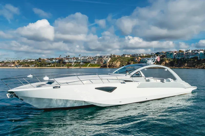 Slide: The Image of Luxurious 2017 Custom Model 60 yacht cruising near scenic coastal homes under a blue sky. - 6