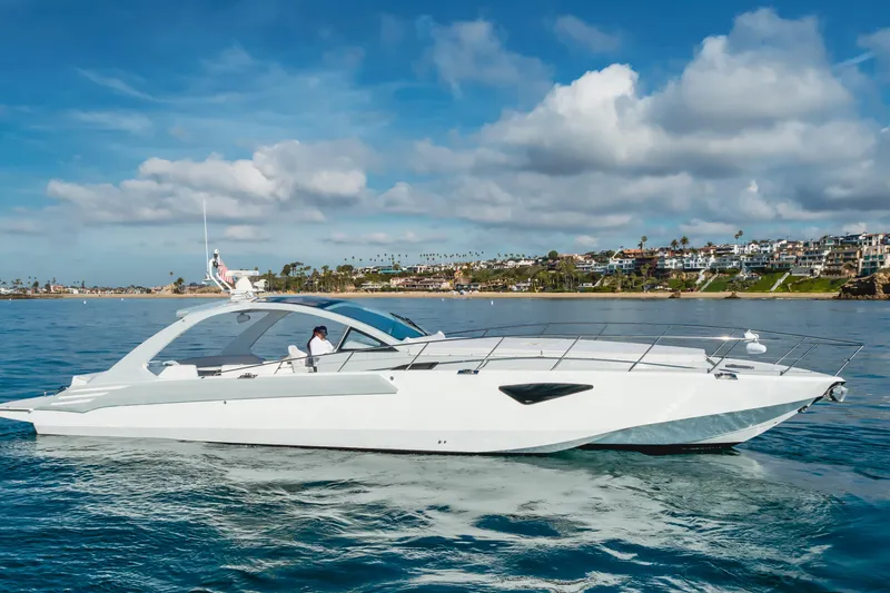 Slide: The Image of Luxurious 2017 Custom 60 yacht cruising near scenic coastal homes under a blue sky. - 7