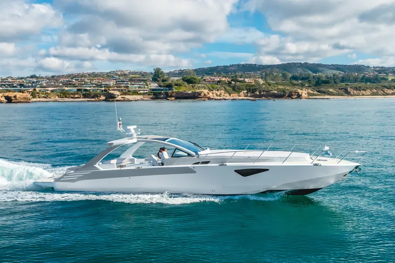 Slide: The Image of Luxurious 2017 Custom 60 yacht cruising on serene blue waters near a scenic coastline. - 9