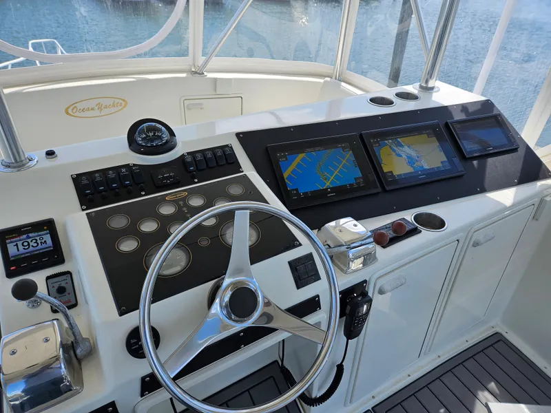 Slide: The Image of Cockpit of 1998 Ocean Yachts 40 Super Sport with navigation screens and steering wheel. - 11