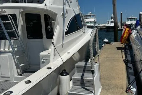 Slide: The Image of 1998 Ocean Yachts 40 Super Sport docked at marina under clear blue sky. - 29