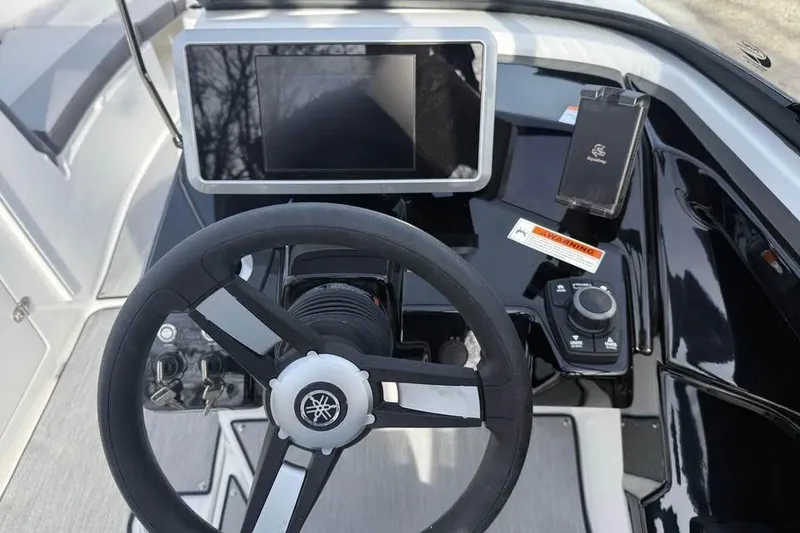 Slide: The Image of 2026 Yamaha Boats AR250 dashboard with steering wheel and touchscreen display. - 10