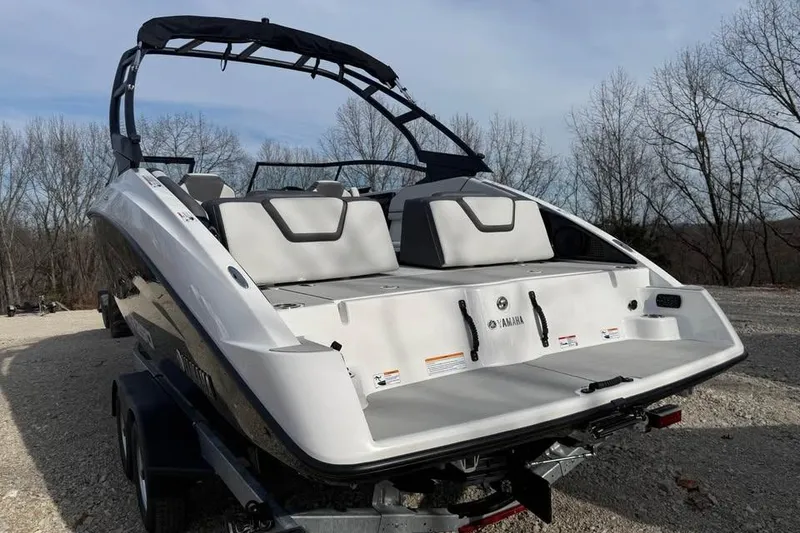 Slide: The Image of 2026 Yamaha Boats AR250 on trailer, rear view, outdoors with trees in background. - 8