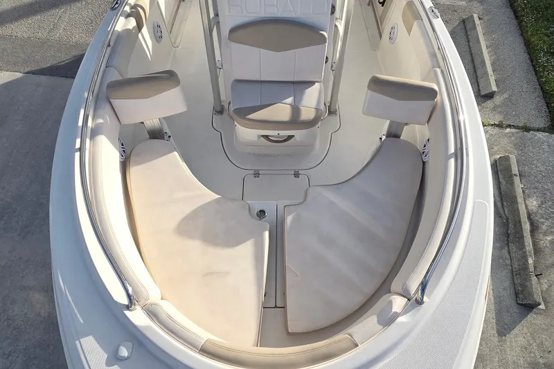 Slide: The Image of 2016 Robalo R222 Center Console boat interior with cushioned seating and console. - 14