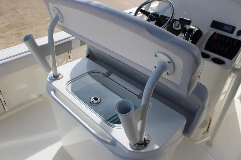 Slide: The Image of 2025 Mako 214 Center Console boat with open storage compartment and rod holders. - 14