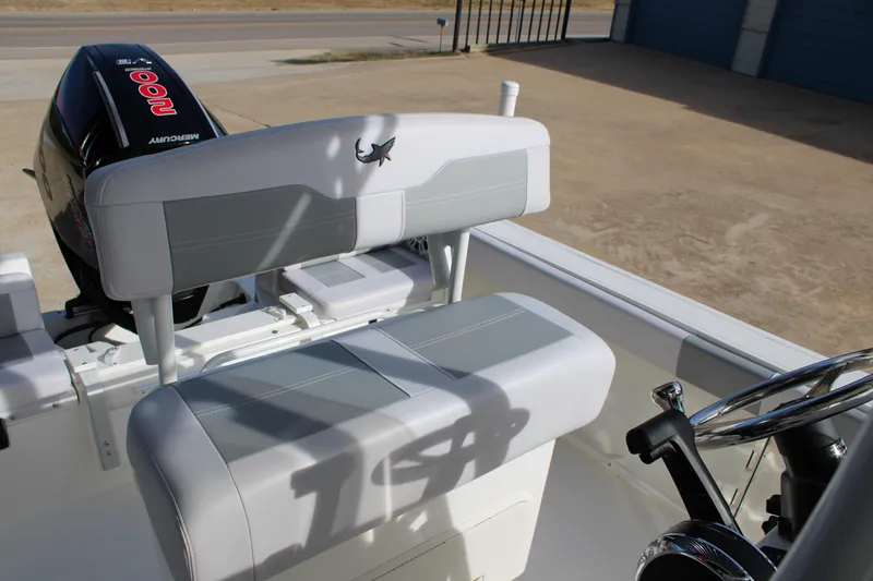 Slide: The Image of 2025 Mako 214 Center Console boat interior with Mercury engine and cushioned seating. - 16