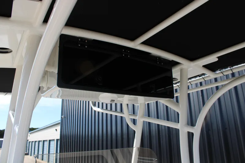 Slide: The Image of 2025 Mako 214 Center Console boat's T-top structure with integrated electronics. - 17