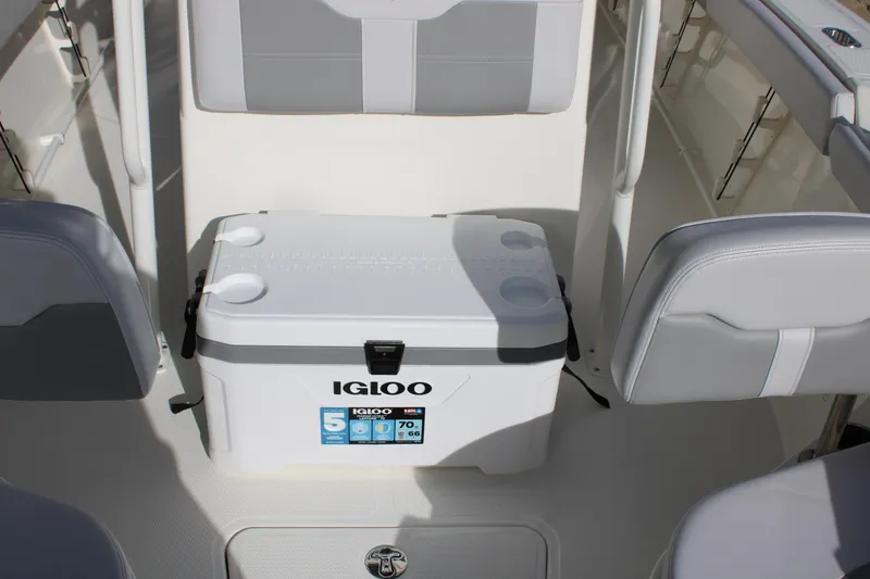 Slide: The Image of 2025 Mako 214 Center Console boat interior with Igloo cooler and seating. - 23