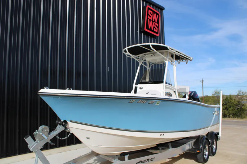 Slide: The Image of 2025 Mako 214 Center Console boat on trailer, parked outside SWWS building. - 3