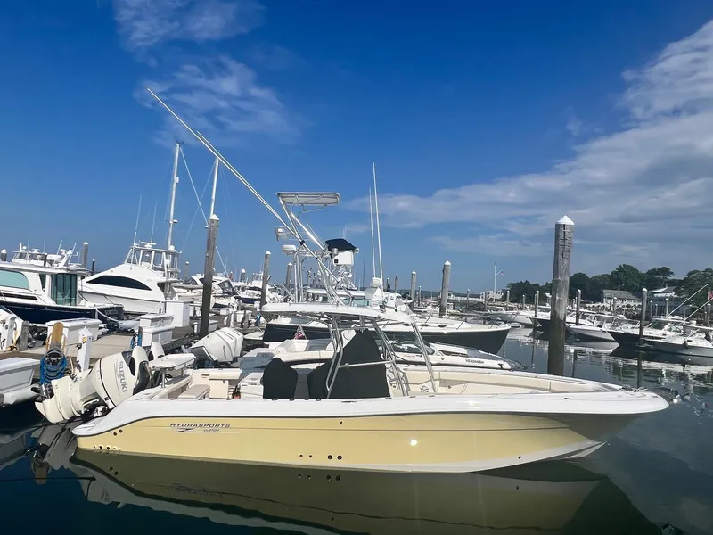 The Image of 2005 Hydra-Sports Vector 3300 CC boat docked in a marina under a clear blue sky. - 0