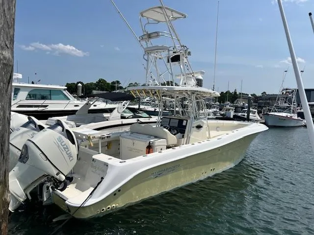 Slide: The Image of 2005 Hydra-Sports Vector 3300 CC boat docked in marina, featuring Suzuki outboard engines. - 2