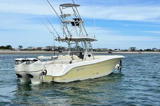 Slide: The Image of 2005 Hydra-Sports Vector 3300 CC boat with dual Suzuki engines on calm water. - 3