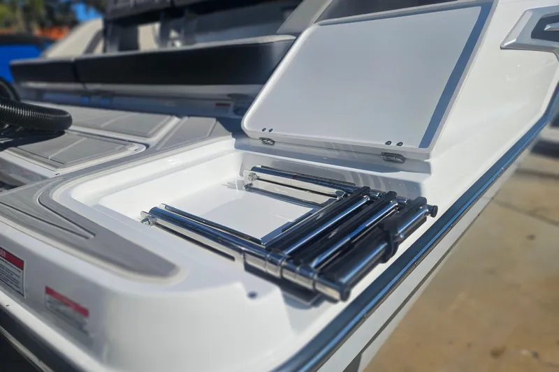 Slide: The Image of 2026 Monterey Elite 30 OB boat with open storage compartment and metal fittings. - 10