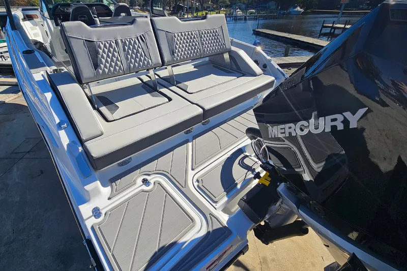 Slide: The Image of 2026 Monterey Elite 30 OB boat with Mercury engine, featuring luxurious seating and sleek design. - 11