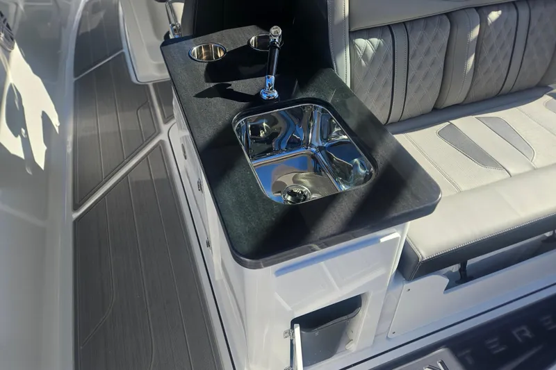 Slide: The Image of Luxury interior of 2026 Monterey Elite 30 OB boat with sink and seating. - 16