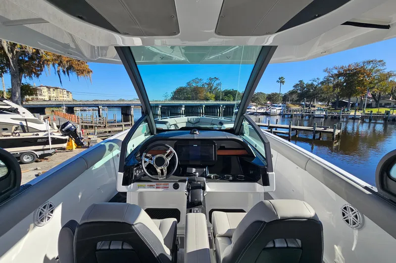 Slide: The Image of 2026 Monterey Elite 30 OB boat interior with modern dashboard and waterfront view. - 18