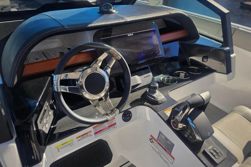 Slide: The Image of 2026 Monterey Elite 30 OB boat dashboard with modern steering and control panel. - 20