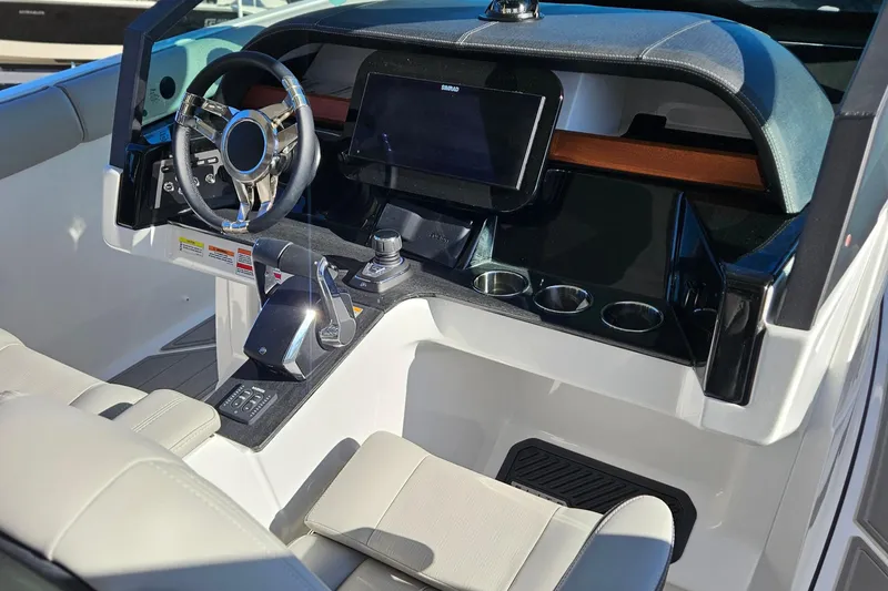 Slide: The Image of Interior of 2026 Monterey Elite 30 OB boat with modern dashboard and steering wheel. - 21