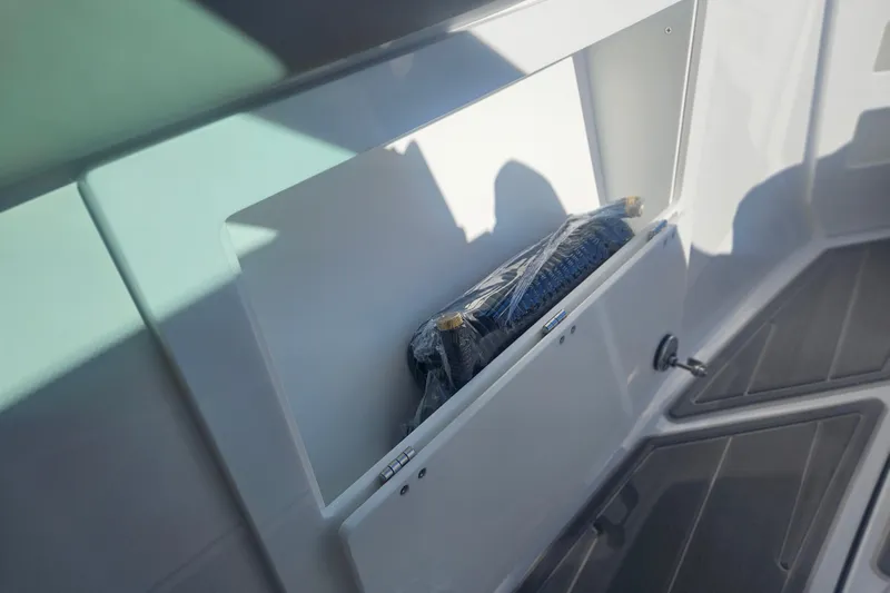 Slide: The Image of Storage compartment on 2026 Monterey Elite 30 OB boat, featuring sleek design and modern finish. - 27