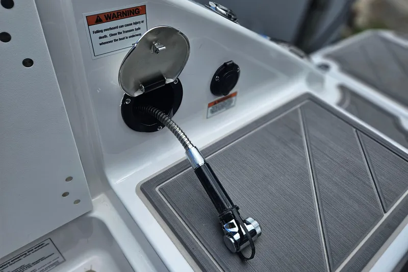 Slide: The Image of 2026 Monterey Elite 30 OB boat deck with fuel inlet and warning label. - 34