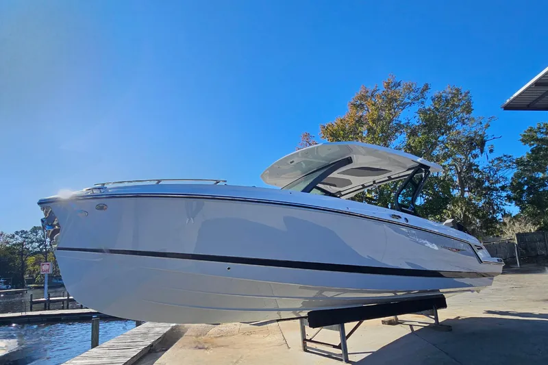 Slide: The Image of 2026 Monterey Elite 30 OB boat on display under clear blue sky. - 7