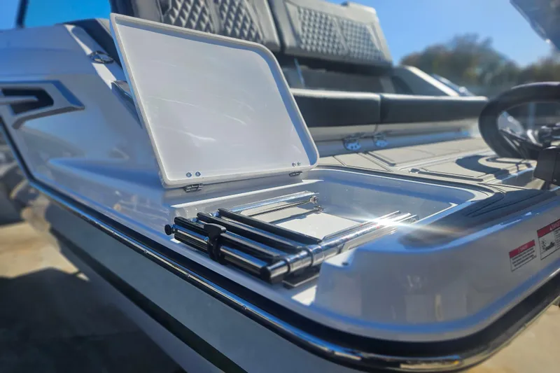 Slide: The Image of 2026 Monterey Elite 30 OB boat with open storage compartment and sleek design. - 8