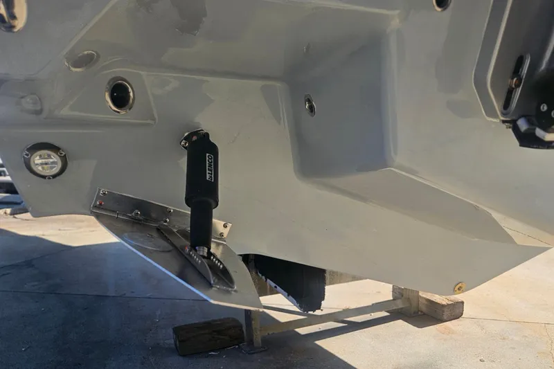 Slide: The Image of 2026 Monterey Elite 30 OB boat hull with trim tab and hydraulic actuator. - 9