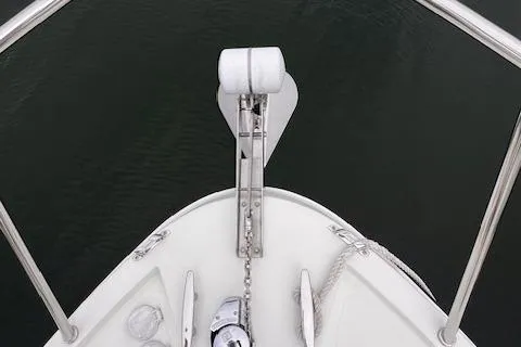 Slide: The Image of Bow of 2004 Sea Sport Voyager 3000 with anchor and chain over water. - 10