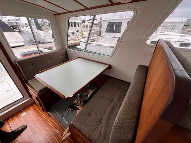 Slide: The Image of Interior of 2004 Sea Sport Voyager 3000 with dining area and marina view. - 18