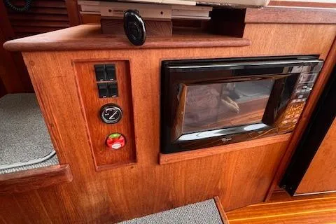 Slide: The Image of 2004 Sea Sport Voyager 3000 interior with microwave and control panel. - 19