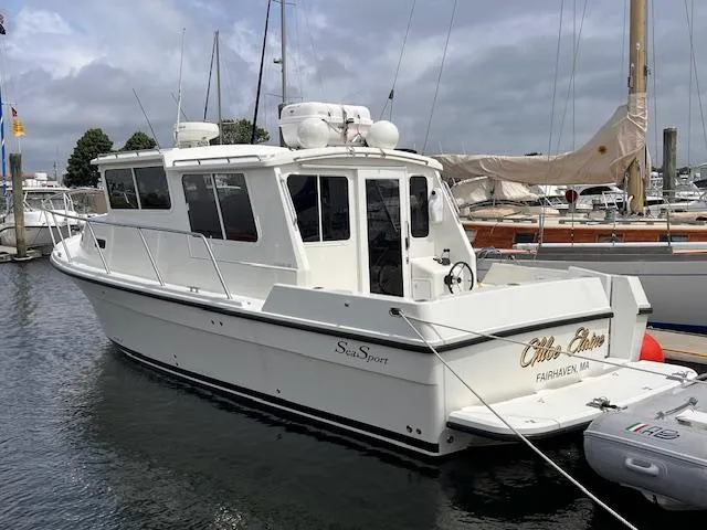 Slide: The Image of 2004 Sea Sport Voyager 3000 boat docked in marina, side view. - 2