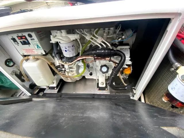 Slide: The Image of Engine compartment of 2004 Sea Sport Voyager 3000 boat, showing detailed mechanical components. - 26
