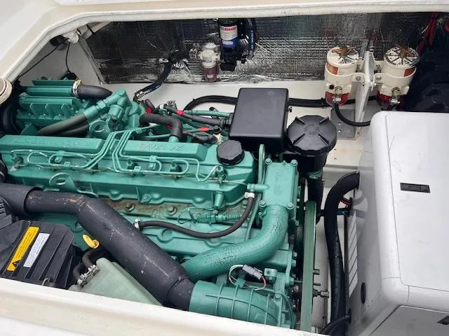 Slide: The Image of Engine compartment of a 2004 Sea Sport Voyager 3000 boat, showcasing detailed machinery. - 28