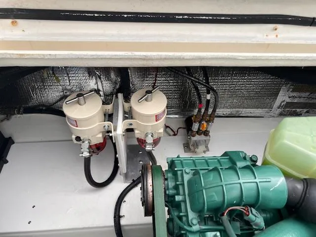 Slide: The Image of Engine compartment of 2004 Sea Sport Voyager 3000 with visible components and wiring. - 30