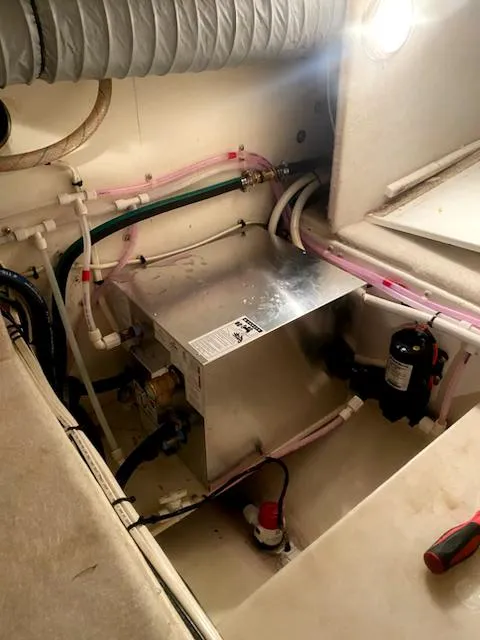 Slide: The Image of Engine compartment of 2004 Sea Sport Voyager 3000 with visible wiring and components. - 31