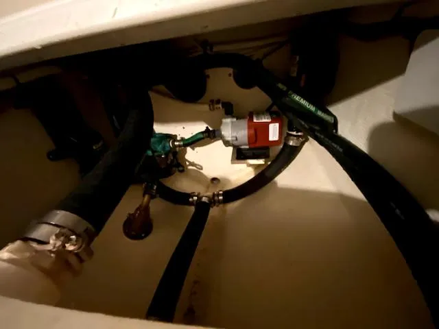 Slide: The Image of Engine compartment of 2004 Sea Sport Voyager 3000 with visible hoses and components. - 33