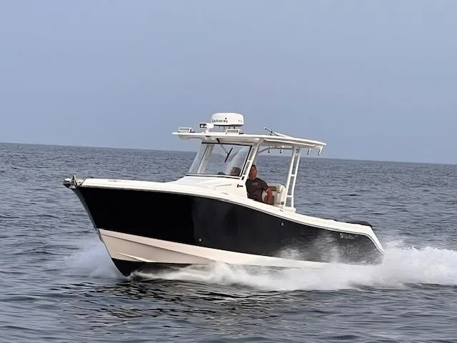The Image of 2015 Edgewater 280CC boat cruising on open water. - 0