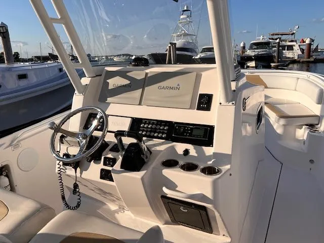 Slide: The Image of 2015 Edgewater 280CC boat cockpit with Garmin navigation system and steering wheel. - 10