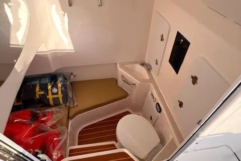 Slide: The Image of 2015 Edgewater 280CC boat interior with toilet and storage area. - 11