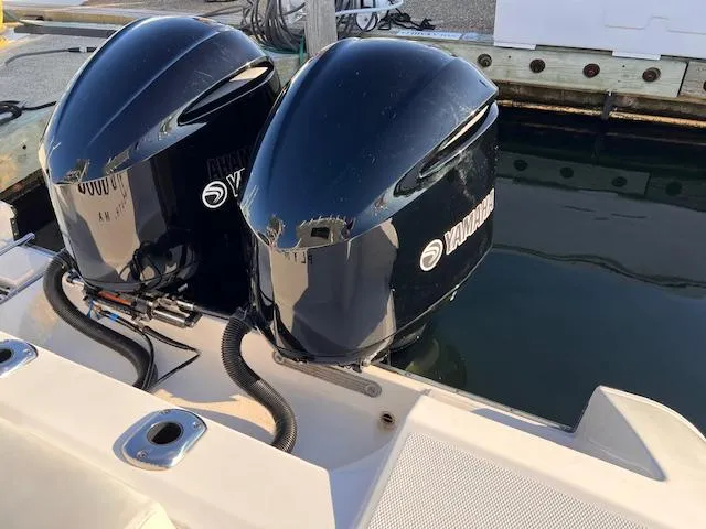 Slide: The Image of Twin Yamaha outboard engines on a 2015 Edgewater 280CC boat at the dock. - 13