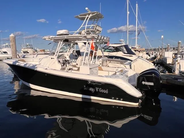 Slide: The Image of 2015 Edgewater 280CC boat docked in marina, sunny day, clear sky. - 3
