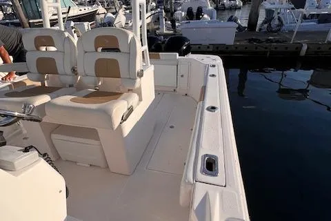 Slide: The Image of Edgewater 280CC 2015 boat interior with seating, docked at marina. - 5