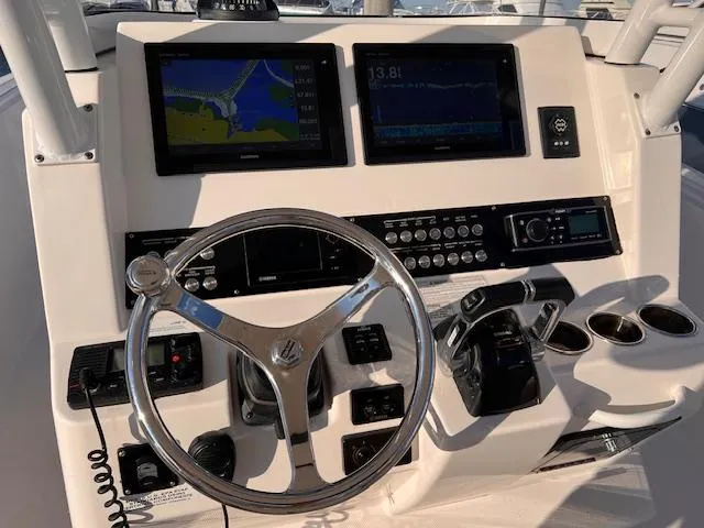 Slide: The Image of 2015 Edgewater 280CC boat dashboard with navigation screens and controls. - 8